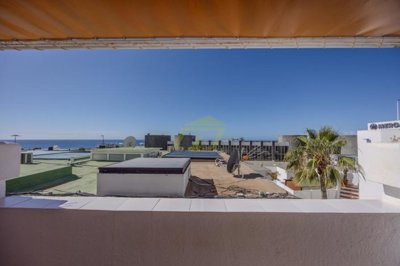 Spacious frontline property moments from the beach with a communal pool