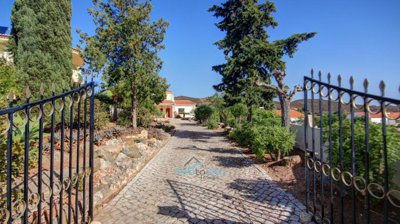 gated entrance and cobblestone drive