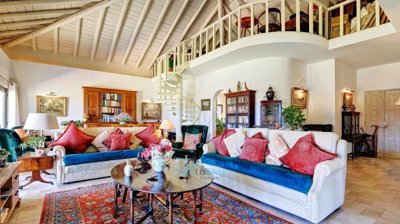 large colonial style living room with vaulted ceiling