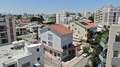 Three storey semi-detached mixed use building with shop and attic in Strovolos, Nicosia