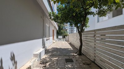 Three storey semi-detached mixed use building with shop and attic in Strovolos, Nicosia