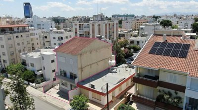 Three storey semi-detached mixed use building with shop and attic in Strovolos, Nicosia