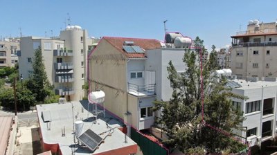 Three storey semi-detached mixed use building with shop and attic in Strovolos, Nicosia