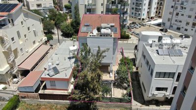 Three storey semi-detached mixed use building with shop and attic in Strovolos, Nicosia