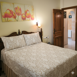 elegant-bedroom-with-a-carved-wooden-headboar