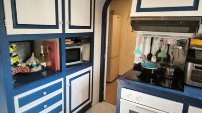 blue-white-kitchen-with-hanging-storage-and-c
