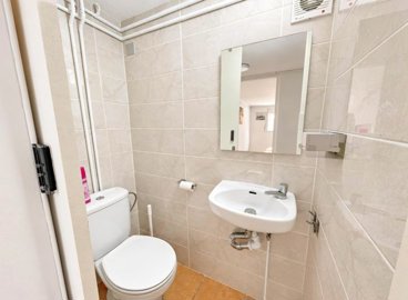 a-bright-small-bathroom-with-a-mirror-and-a-w