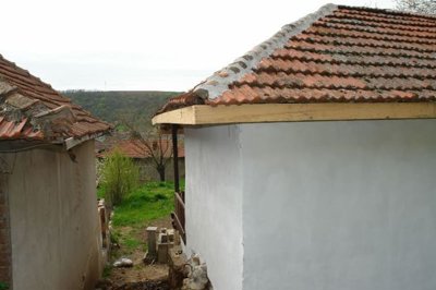 Covered well or water access point with metal lid in garden