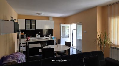 Living room with black and white sofa and round dining table
