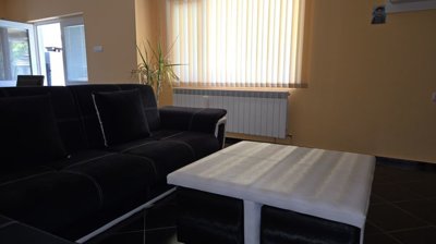Living room featuring black and white sofa and white coffee table
