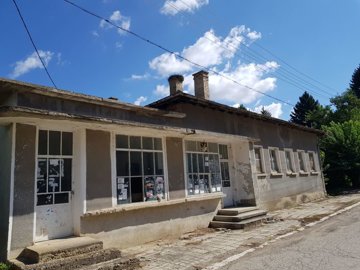 Close-up side view of the bakery building highlighting windows and entrance steps