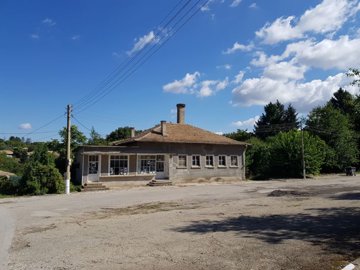 Wide angle image showing the bakery building situated on a street corner with clear sky