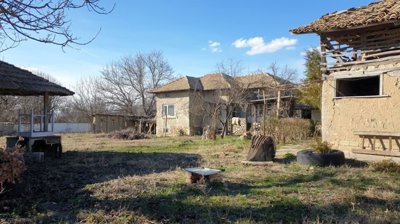 Open garden space surrounded by traditional Bulgarian houses with tiled roofs and leafless trees