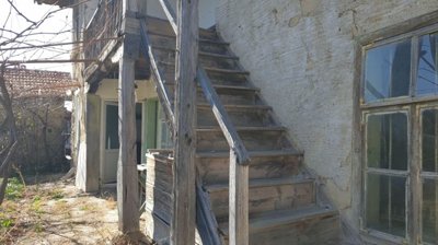 Detailed view of wooden stairs and balcony railing on traditional Bulgarian house