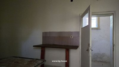 Interior view of shelving units, counter, and doorway to another room