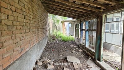 Covered outdoor space with brick walls and wooden beams
