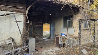 Covered outdoor storage area with blue doors and items