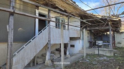 Exterior view of house showing stairs, porch, and outdoor seating area