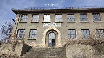 Detailed view of the main entrance with stone arch and steps leading up