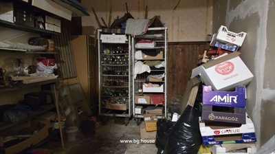 Storage room containing metal shelving units filled with boxes and assorted stored items