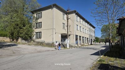 Street corner view showing the three-storey business complex surrounded by trees and pedestrians