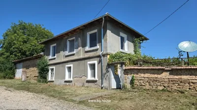 Two-story house with six visible windows and a metal downspout on the corner