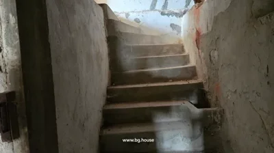 Concrete staircase with curved steps and unfinished walls